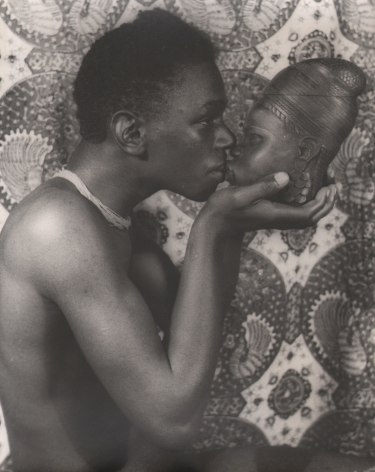 01. Carl Van Vechten, Allen Meadows, c. 1940. Waist-up portrait of the figure, shirtless, in profile, holding a traditional mask to face him so they are nose-to-nose.