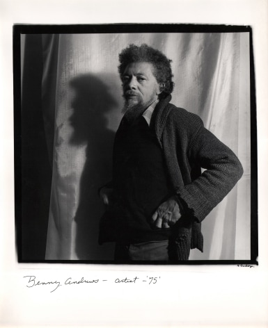Anthony Barboza, Benny Andrews &ndash; Artist, 1975. Subject stands in the center of the square frame facing left with hands on hips against a shiny fabric background.