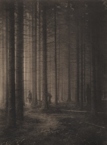 01. L&eacute;onard Misonne, Les bucherons, c. 1934. Three lumberjacks amongst tall trees. Sepia-toned print.