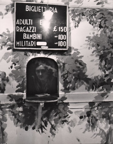 Alfredo Camisa, Botteghino del Circo, ​1956. A woman peers out from a ticketing booth beneath a sign with ticket prices.