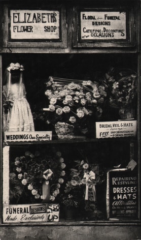 2. Beuford Smith, Harlem, NY, ​n.d. Shop window of &quot;Elizabeth's Flower Shop&quot; with various floral arrangements and signs describing services.