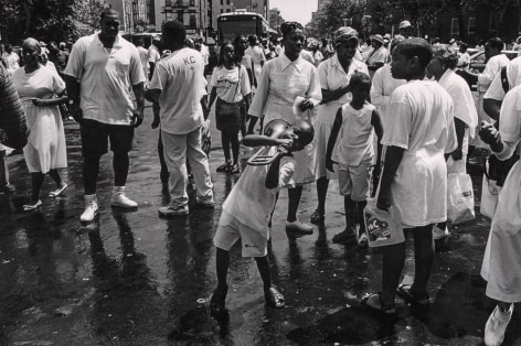 04.&nbsp;Boy bends notes on a broken trombone: more than a hundred followers of Daddy Grace gather in Central Harlem for an annual August street baptism, organized by the United House of Prayer, 1994.