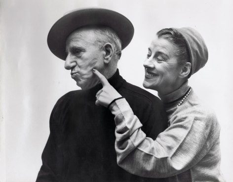 Richard Avedon, Jimmy Durante &amp; Beatrice Lillie, ​1951. A woman stands to the right, smiling towards a man in black. She points to the lipstick mark on his left cheek. Both have heads turned to the left.