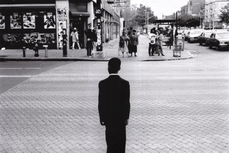 Church Boy: A boy stands on the corner of 125th Street and Adam Clayton Jr. Boulevard a moment before he crossed on his way to church at the United House of Prayer For&nbsp;All People, June 1994.