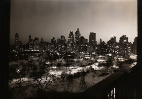Paul J. Woolf, Central Park &amp; 59th Street, ​c. 1936. Night time cityscape with Central Park in the foreground and tall buildings in the background.
