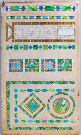 Blue, green, pink and white glass tesserae arranged in patterned formations on a cement ground