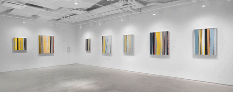 Seven paintings by Alice Trumbull Mason installed in the Washburn Gallery comprised of vertical stripes in ochers, grays, blues, blacks, whites, and reds.