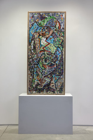 A mosaic by jackson Pollock with colorful tesserae on a vertical rectangular ground.  Mosaic is resting on a grey rectangular base in the gallery space