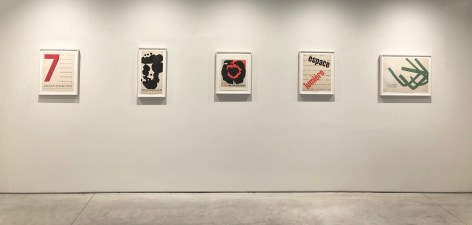 Installation view of five posters by Jack Youngerman.  Red and black graphics, green abstract form