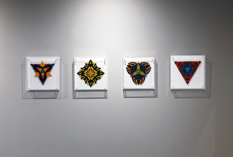 Four works on paper by Jack Youngerman under plexi box frames installed on a white wall
