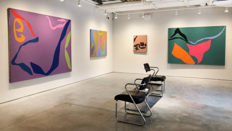 Four paintings installed on a white wall at the Washburn Gallery