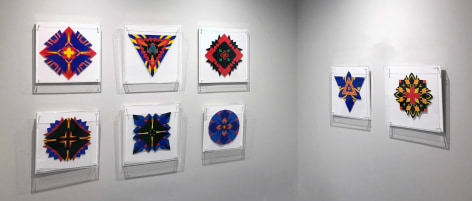 Eight works on paper in blue, yellow, red, black and orange by Jack Youngerman installed on white walls in the corner of the Washburn Gallery