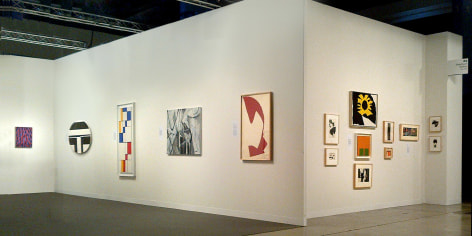 (from left) Myron Stout, Untitled, c. 1950, oil on canvasboard, 20 x 16 in., Ilya Bolotowsky, &quot;Black and White Ellipse, 1963, oil on canvas, 30 x 40 in., Leon Polk Smith, &quot;Diagonal Passage: Red-Blue-Yellow,&quot; 1949, oil on canvas, 54 x 20 in., Nicolas Carone, &quot;Off the Chart,&quot; 2009, acrylic on tarpaulin, 33 x 42 in., Leon Polk Smith, Untitled, 1964, torn paper drawing, 39 x 25 in., (right wall) Small works by Nicolas Carone, Reuben Kadish, Alice Trumbull Mason, Doug Ohlson, Ray Parker, Leon Polk Smith, Richard Stankieiwcz, and Jack Youngerman