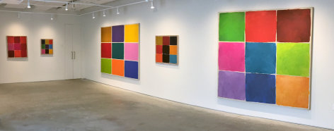 Five paintings on two white walls in the Washburn Gallery