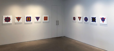 Ten works on paper by Jack Youngerman under plexi box frames installed on white walls