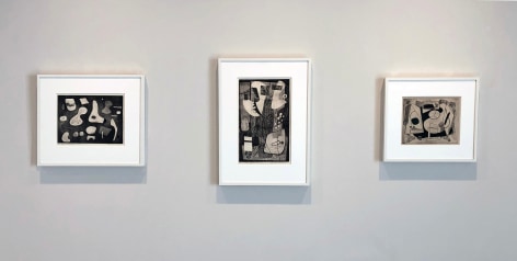 Three black and white prints by Alice Trumbull Mason in white frames installed on a white wall