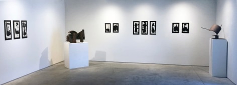 Installation view of ten black ink drawings on white paper attached to black matts by Richard Stankiewicz with two sculptures by the artist made of galvanized steel and found metal