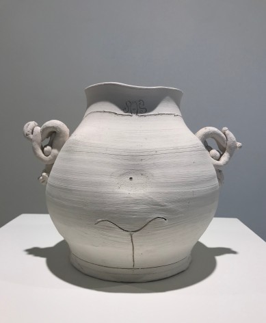 A white vessel resting on a white table
