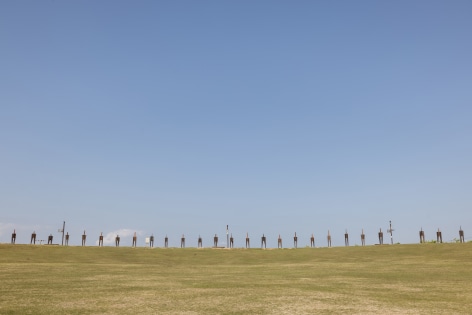 Chung Hyun, The Standing Man, 2021. Railroad tie, Dimensions variable (each figure: 75 x 53 x 320(h) cm)., Courtesy of the artist &amp;amp; PKM Gallery.