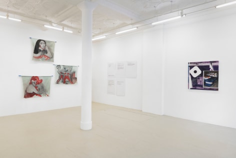 and installation view of the exhibition showing the stacked paintings, the text panels and a purple painting