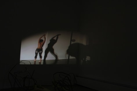 A photograph of a video projection, the room is otherwise dark