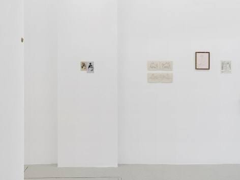 An installation view of 3 works on paper installed on the wall, without frames