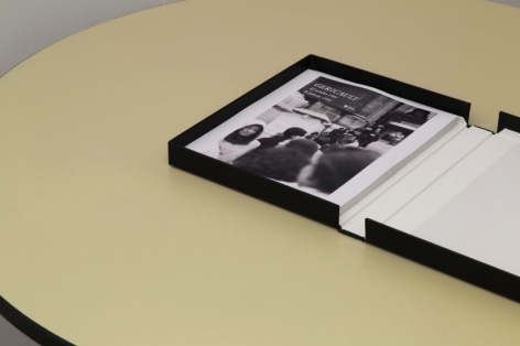 An photograph of an open binder with a single black and white photograph.