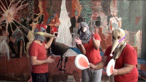 A film still of three people in bird masks, standing against a textures and collaged background