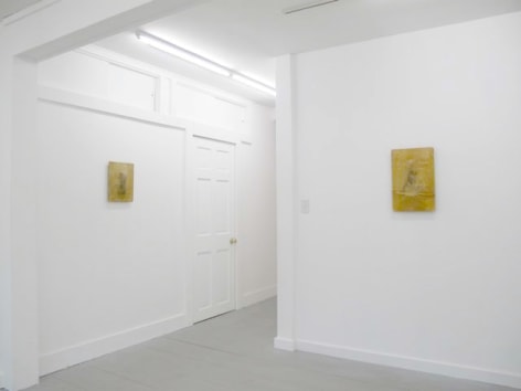 A photograph of 2 artworks on 2 white walls, perpendicular to one another