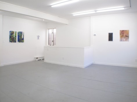 A photograph of 5 works on 2 walls