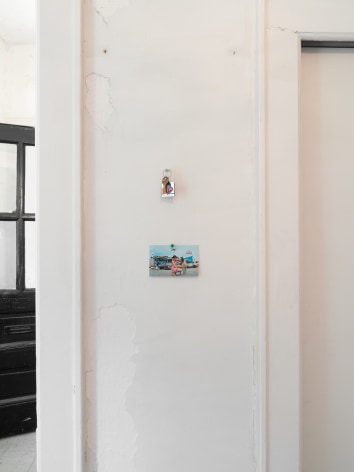 A photograph of two items installed to the right of the front door in the installation