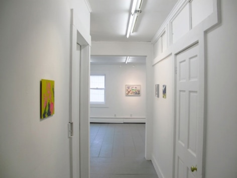 A photograph of 4 artworks: 3 on opposite sides in a hallway and one at the far end of the next room