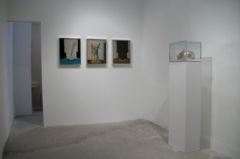 A photograph of the back of the gallery, with 3 works on the back wall and one sculpture on a white pedestal