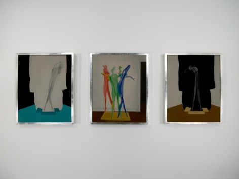 A photograph of 3 paintings in silver frames hung on the wall
