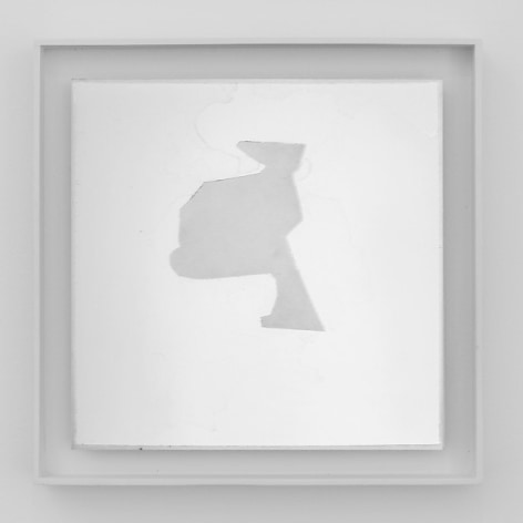 An artwork framed in white. On a white ground, there is an abstract shape that is centrally situated in a square composition. The shape is gray.