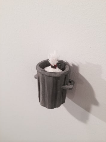 A small trash can hung on the wall