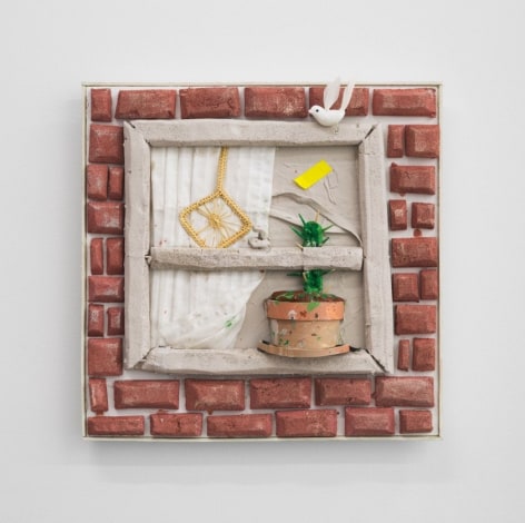 A sculptural depiction of a window from the outside: bricks surround it, there is a curtain at left and a cactus in the sill.