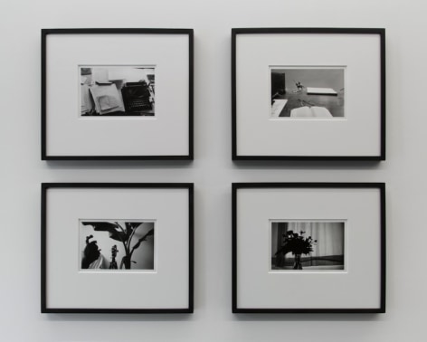 A photograph of 4 black and white images, framed in black, in a square formation
