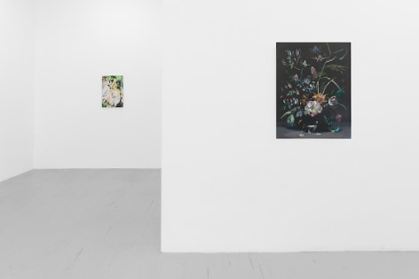 A close view photograph of a painting on black ground on the gallery's temporary wall with flowers. The back wall has an abstract painting with tones of orange, yellow, and green.