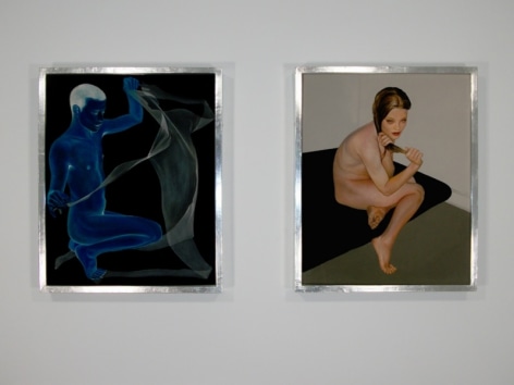 A photograph of 2 artworks on the wall, framed in silver, with figures