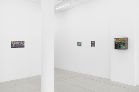 An installation image of 3 paintings and 1 sculpture by Nicholas Buffon hung on the wall