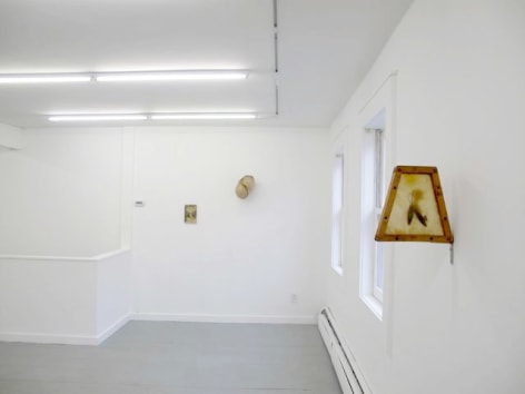 A photograph of the same 3 works on 2 walls, from a different angle