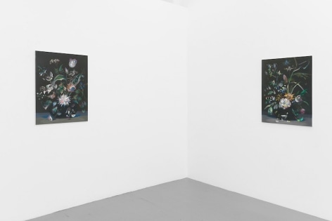 Two paintings mirroring each other on the corner of the room. They resemble one another.