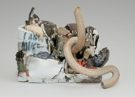 A sculpture of mixed stoneware. There are several serpentine tube shapes, silver lusters and seemingly molten elements that appear to drip over. At left is a shape that resembles a paint can with the works &quot;I AM MIKE&quot; written upon it.