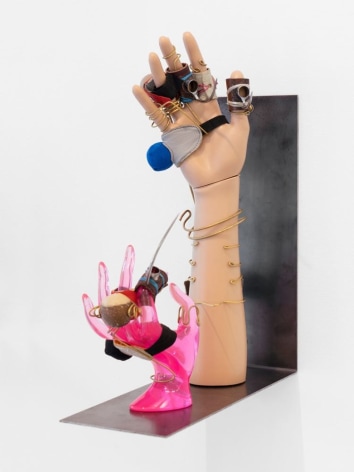 A steel shelf that holds 2 mannequin hands (one wood, one pink plastic) that are outfitted with muffs and gaffs