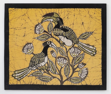 A textile with a black border; three hornbill birds are gathered in the middle of a yellow background. They are green, black, yellow, and white in color, very graphic