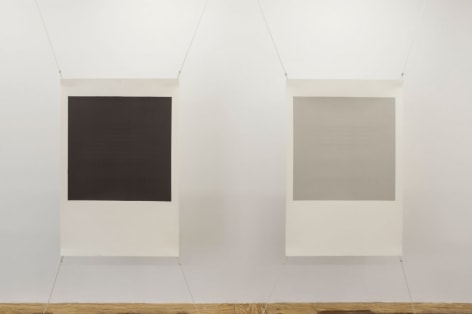 A view of 2 screenprints by Bergvall stretched at four corners with wire. On the left, the center is black with a white border; at right the center is gray with a white border.