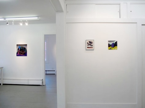 A photograph of 3 artworks: 2 on the closest wall, 1 on a wall in the background at left