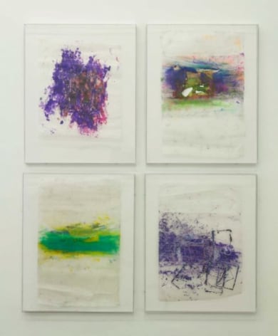 A photograph of four colored drawings on wax paper, framed, arranged in a square.