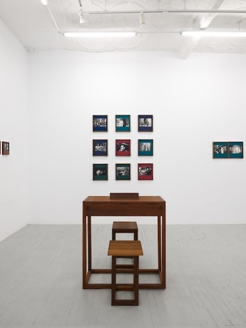 An installation view of Dayanita Singh's exhibition, which includes &quot;Museum of Gestures,&quot; a custom desk with 2 chairs, and a diptych, &quot;Mona and Louise&quot;